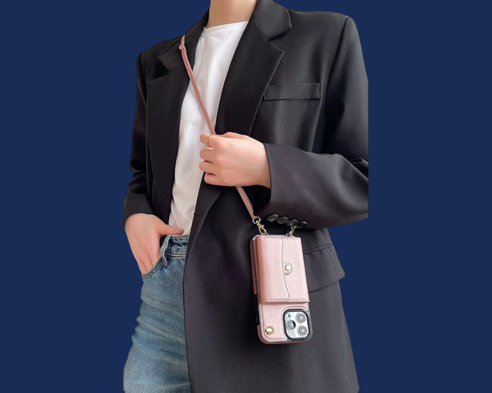 Pink lanyard phone case with cardholder and strap, styled with a blazer and casual outfit