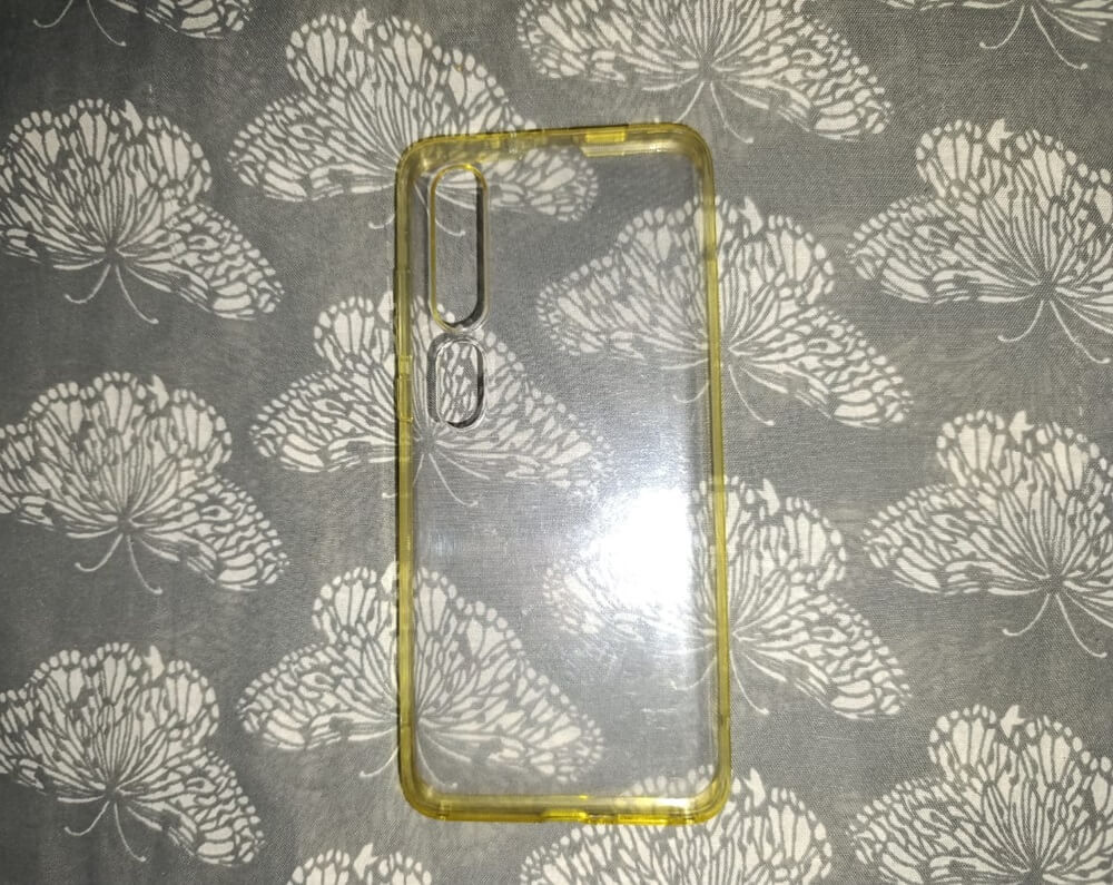 A transparent yellow phone case due to age and use. The discoloration highlights the effects of wear.